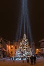Illuminated, snowy Christmas tree with decorations and laser beams, Kuldiga, Latvia