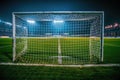 Illuminated Soccer Goal Post and Net at Night in Empty Stadium with Vibrant Grass Field and Stadium Lights Royalty Free Stock Photo