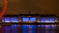 Illuminated Southbank City Hall reflects on a soft Thames river