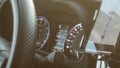 Illuminated speedometer dashboard and steering wheel of a modern car in a sun flare Royalty Free Stock Photo