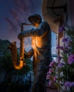 Illuminated statue of a jazz player at night in Subotica, Serbia Royalty Free Stock Photo