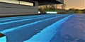 Illuminated steps under warm water of the amazing rooftop pool of the stunning suburban cottage in the night. 3d rendering Royalty Free Stock Photo