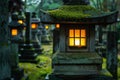 Illuminated stone lantern in a serene Japanese garden at dusk Royalty Free Stock Photo