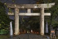 Illuminated stone torii sacred gate at night in Ueno Toshogu shrine.