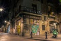 Illuminated street with graffiti walls