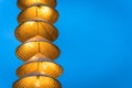 Illuminated stripe Vietnamese traditional conical hats hanging on wire for decoration, with blue sky at twilight Royalty Free Stock Photo