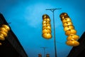 Illuminated stripe Vietnamese traditional conical hats hanging on wire for decoration, with blue sky at twilight Royalty Free Stock Photo