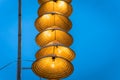 Illuminated stripe Vietnamese traditional conical hats hanging on wire for decoration, with blue sky at twilight Royalty Free Stock Photo