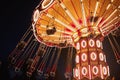 Illuminated swing chain carousel in amusement park at the night Royalty Free Stock Photo