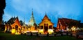 Illuminated temples of Wat Phra Singh in Chiang Mai, Thailand at sunset Royalty Free Stock Photo