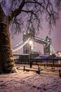 The illuminated Tower Bridge of London on a winter evening with snow and ice Royalty Free Stock Photo