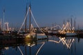 Illuminated traditional wooden fishing ships at night in Dutch harbor Royalty Free Stock Photo