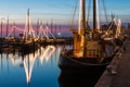 Illuminated traditional wooden fishing ships at night in Dutch harbor