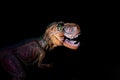 Illuminated Tyrannosaurus head in the dark closeup