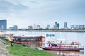 Tourist river cruise boats,lit up at dusk,await customers,Phnom Penh,Cambodia Royalty Free Stock Photo