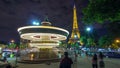 illuminated vintage carousel close to Eiffel Tower night timelapse, Paris Royalty Free Stock Photo