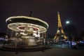 Illuminated vintage carousel and Eiffel Tower at night, Paris