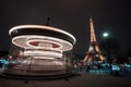 Illuminated vintage carousel and Eiffel Tower at night, Paris