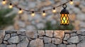 Illuminated vintage lantern hangs over a stone wall with string lights creating a cozy atmosphere Royalty Free Stock Photo