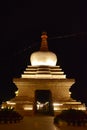 Illuminated white stupa next to the Potala Palace in Lhasa, Tibet Royalty Free Stock Photo