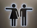 Illuminated women's and men's toilet sign. Royalty Free Stock Photo