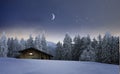 Illuminated wooden hut in a winter night Royalty Free Stock Photo