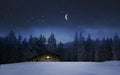 Illuminated wooden hut in a winter night