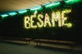 Illuminated 'besame' sign over benches in Malaga Royalty Free Stock Photo