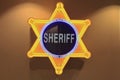 Illuminated yellow neon Sheriff`s badge