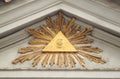 Illuminati sign on building pediment close up