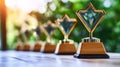 Illuminating Array of Golden Corporate Trophies on a Table Symbolizing Winning Teamwork and Success Royalty Free Stock Photo