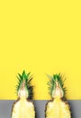 Illuminating Yellow, Ultimate gray colors of the year 2021. Trendy background concept with two half pineapples