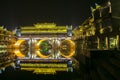 illumination lights decoration of bridge in FengHuang village reflect as a circle on river with traditional chinese houses