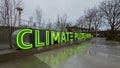 Illuminated green Climate Pledge Arena sign at the Seattle venue in the rain