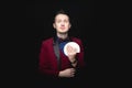 Illusionist man shows fan of playing cards in his hand on black background Royalty Free Stock Photo