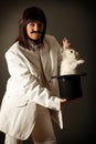 Illusionist with rabbit in black top hat Royalty Free Stock Photo