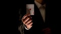 Illusionist showing ace of heart card at camera, magic trick, black background Royalty Free Stock Photo