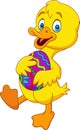 Cartoon duckling holding a decorated Easter egg Royalty Free Stock Photo