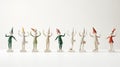 Illustrate a group of playful elf figurines in various poses on white background