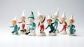 Illustrate a group of playful elf figurines in various poses on white background