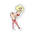 retro distressed sticker of a cartoon pin up girl putting on stockings