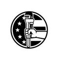 Hand of American Plumber Holding Pipe Wrench USA Flag Circle Retro Black and White Royalty Free Stock Photo