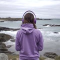 Illustration of a back-to-back teenager with headphones looking out to sea. Royalty Free Stock Photo