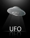 Illustration banner flying saucer UFO on a dark black background shines a beam of light on the inscription with a reflection for