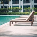 Empty deck chair around outdoor swimming pool in hotel resort for leisure vacation.