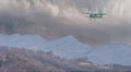 Illustration of biplane flying over rough mountainous terrain