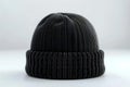 A black beanie hat viewed from the front in product photography with studio lighting against a white background. the image ha Royalty Free Stock Photo