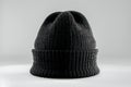A black beanie hat viewed from the front in product photography with studio lighting against a white background. the image ha Royalty Free Stock Photo