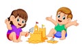 Boy and girl making a big sandcastle at beach