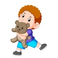 A boy happy play with the grey teddy bear Royalty Free Stock Photo
